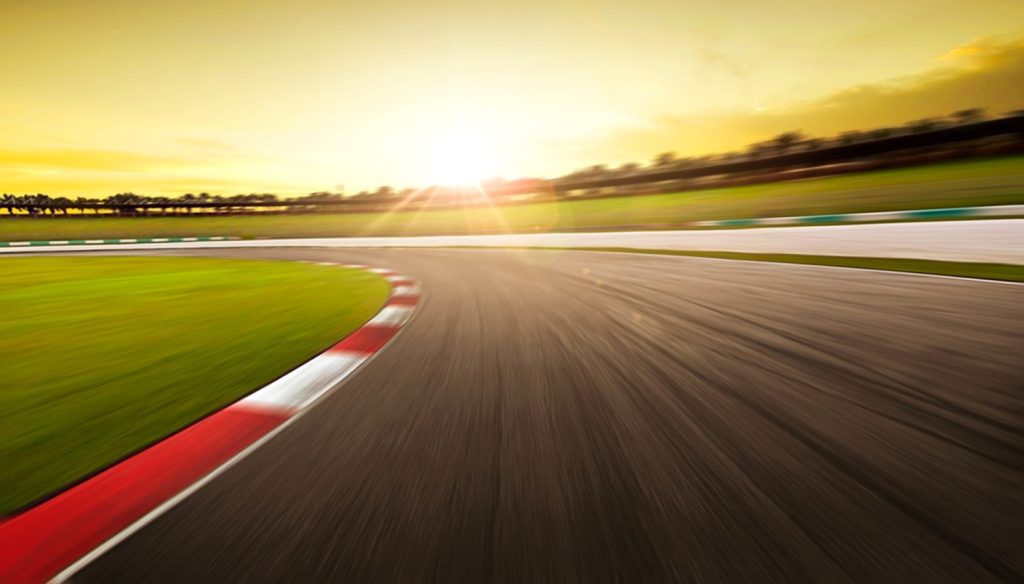 track for cars at speedway with sunset