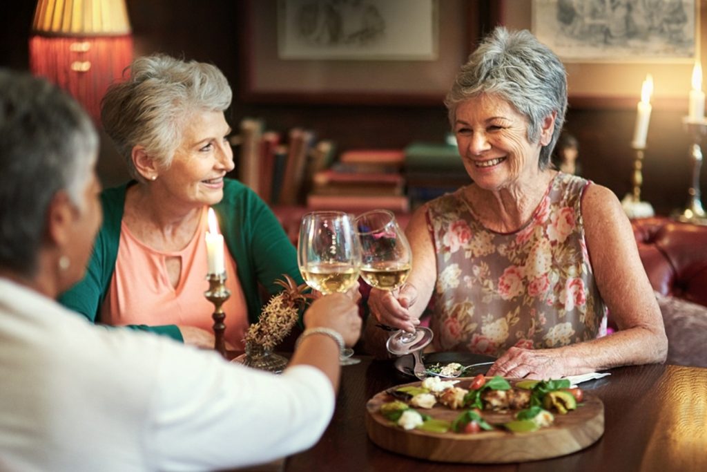 elderly people with wine at a restaurant