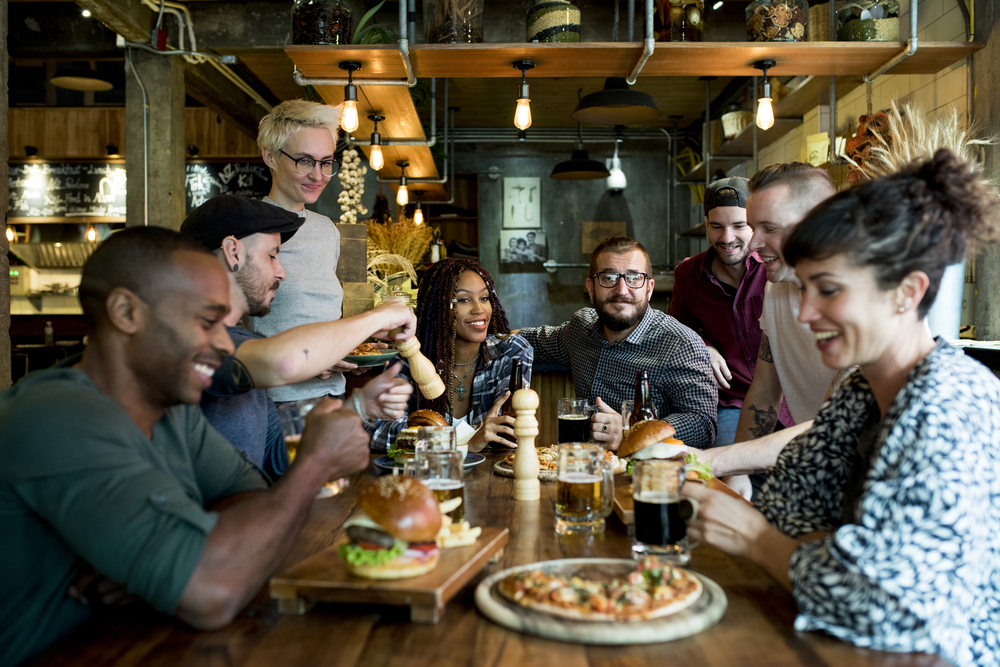 Diverse group of friends at a restaurant eating