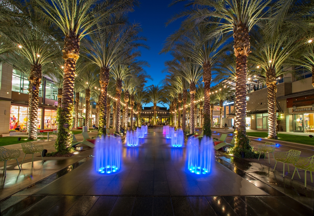 Fountains surrounded by palm trees during the night time