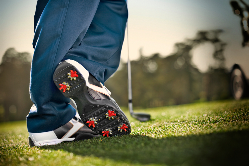 Close up shot on a person wearing golfing shoes