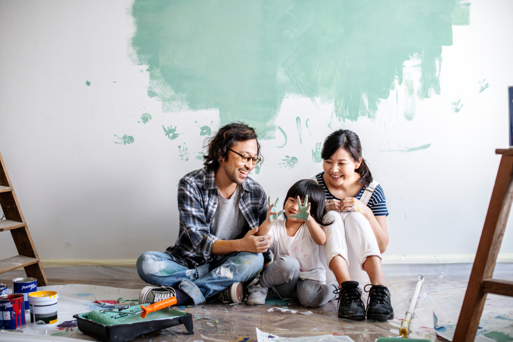 Family renovating house and laughing together